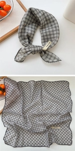 Macro detail of black and gray plaid cotton linen scarf with elegant lace trim edge