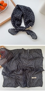 Close-up of dark floral cotton-linen feel scarf with intricate crochet lace borders