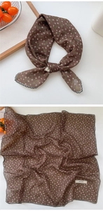 Close-up of brown floral scarf with white flowers and black scalloped lace borders