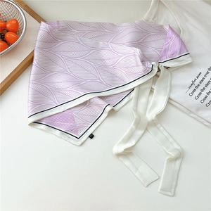 Dettaglio foulard in raso con stampa a foglie viola e chiusura magnetica a perla