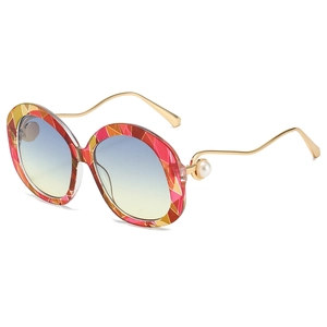 Fashionable oval sunglasses with geometric frame, golden wave temples, and pearl detail