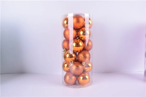 Detail of 3cm orange Christmas balls set in transparent tube with matte and glitter finishes