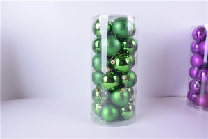 Detail of 3cm green and purple Christmas balls with matte and glitter finishes in a tube