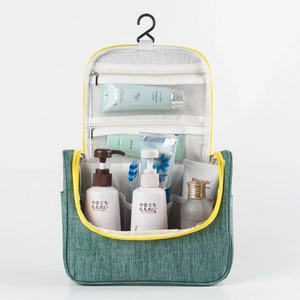 Detail of hanging toiletry bag interior showing mesh pockets and hook with travel essentials