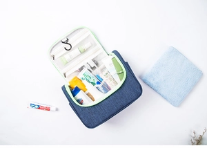 Detail of hanging toiletry bag with multiple mesh pockets and a portable metal hook