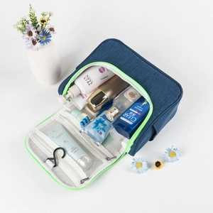 Detail of blue travel toiletry bag with neon green lining and multiple mesh compartments