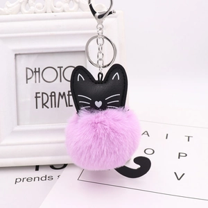 Close-up of pink faux rabbit fur pom pom keychain with black PU leather cat face charm