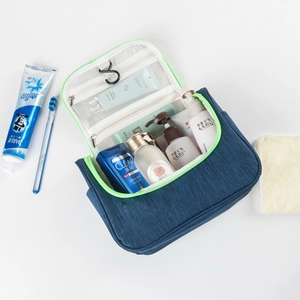 Detail of navy travel toiletry bag with neon green zippers and internal hanging hook