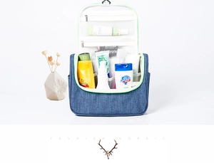 Blue hanging travel toiletry bag with mesh pockets and fluorescent green trim detail