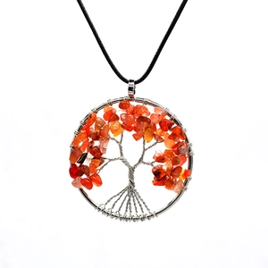 Detail of handmade Tree of Life wire wrapped pendant with orange gemstones and black cord