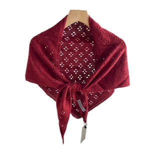 Deep red knit shawl with hollow heart pattern on wooden hanger against white background