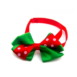 Detailed view of Halloween pet bow tie in red and green satin with pink polka dots
