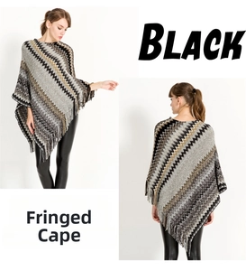 Detail shot of fringe tassels and geometric striped pattern on the women's knitted cape
