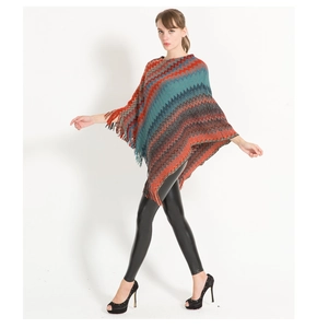 Detailed view of women's knitted poncho featuring colorful zigzag patterns and fringe edges