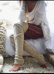 Close-up of knit leg warmer featuring intricate hollow crochet and cable patterns