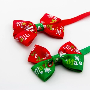 Detailed view of red and green Christmas pet bow ties with snowflake prints