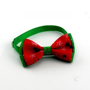 Detail view of festive Christmas pet bowtie with snowflake patterns and white buckle