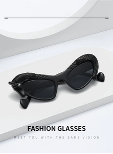 Detail of artistic black sunglasses featuring Pegasus relief and heart-shaped temple tips