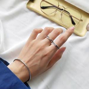 Detail view of S925 sterling silver minimalist cuff bracelet and engraved arrow ring