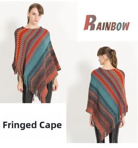 Detail showing the colorful zigzag rainbow pattern and long fringe on this stylish cape
