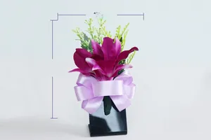 Detail of purple artificial orchid boutonniere with satin bow, 11cm high by 7cm wide