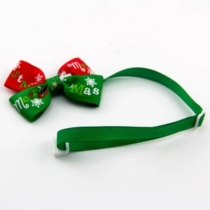 Close-up of Merry Christmas pet bow tie with adjustable white buckle and festive patterns