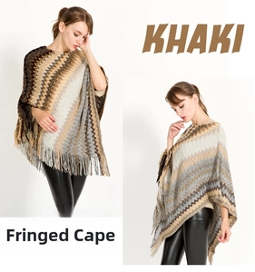 Detail of khaki zig-zag knit poncho featuring long fringed tassels and tribal pattern