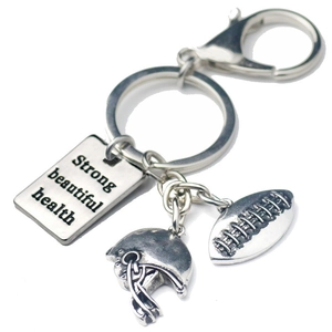 Silver rugby metal keychain with helmet charm and engraved Strong Beautiful Health tag