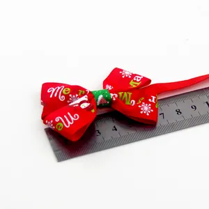 Detail of red Christmas pet bow tie with snowman print, measuring 7.5cm width on ruler