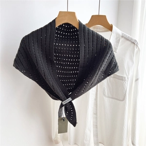 Close-up of dark grey hollow-out knitted triangle scarf with textured dot pattern
