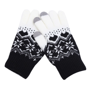 Close-up of winter knit gloves featuring snowflake jacquard patterns and touchscreen tips