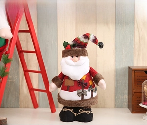 Detail of Santa Claus plush doll with red green plaid hat and festive bow decoration