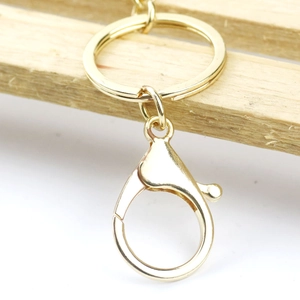 Polished gold boxing glove keychain with large lobster clasp and sturdy keyring for bag