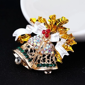 Golden Christmas bell brooch with enamel holly leaves and sparkling rhinestones