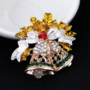 Macro view of Christmas bell brooch with golden bells and rainbow crystals