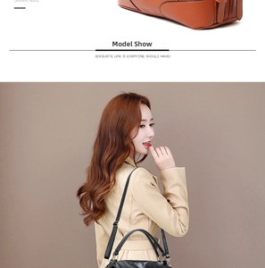 Detail of lychee pattern leather handbags in orange and black with gold hardware