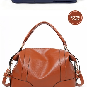 Detailed view of brown leather handbag with fine grain texture and golden metal hooks