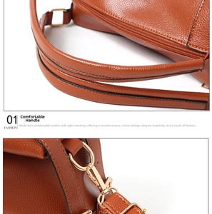 Detail of brown litchi pattern leather handbag showing soft handles and gold hardware
