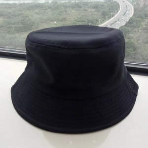 Detail of a black cotton bucket hat texture and stitching on a window sill background