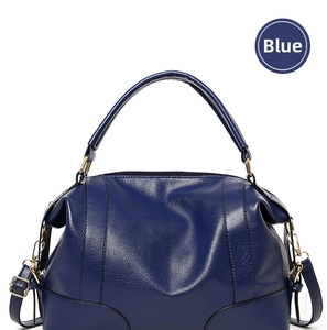 Detailed macro view of the blue litchi pattern leather and handle on the handbag