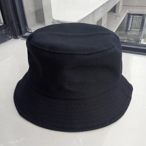 Top-down view of a classic black cotton bucket hat with durable fabric texture details