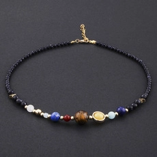 Macro view of solar system theme necklace with colorful planet beads and black stones