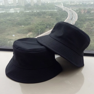 Close-up of two black cotton bucket hats showing fabric texture and stitched brim detail