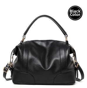 Close-up of black lychee grain leather handbag featuring elegant gold hardware details