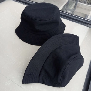 Detailed top view of two black cotton bucket hats with reinforced stitching details