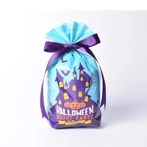 Close-up of Halloween treat bag with haunted house print and purple ribbon bow