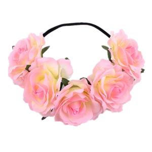 Detailed view of pink and yellow gradient rose floral headband on a slim black band