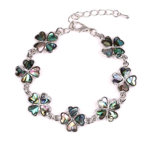Silver bracelet featuring seven colorful abalone shell four-leaf clover charms in a circle