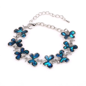Silver butterfly bracelet featuring blue shell inlays and adjustable extension chain