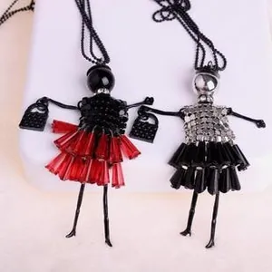 Detail of doll pendant long necklaces with faceted beads and miniature handbag charms